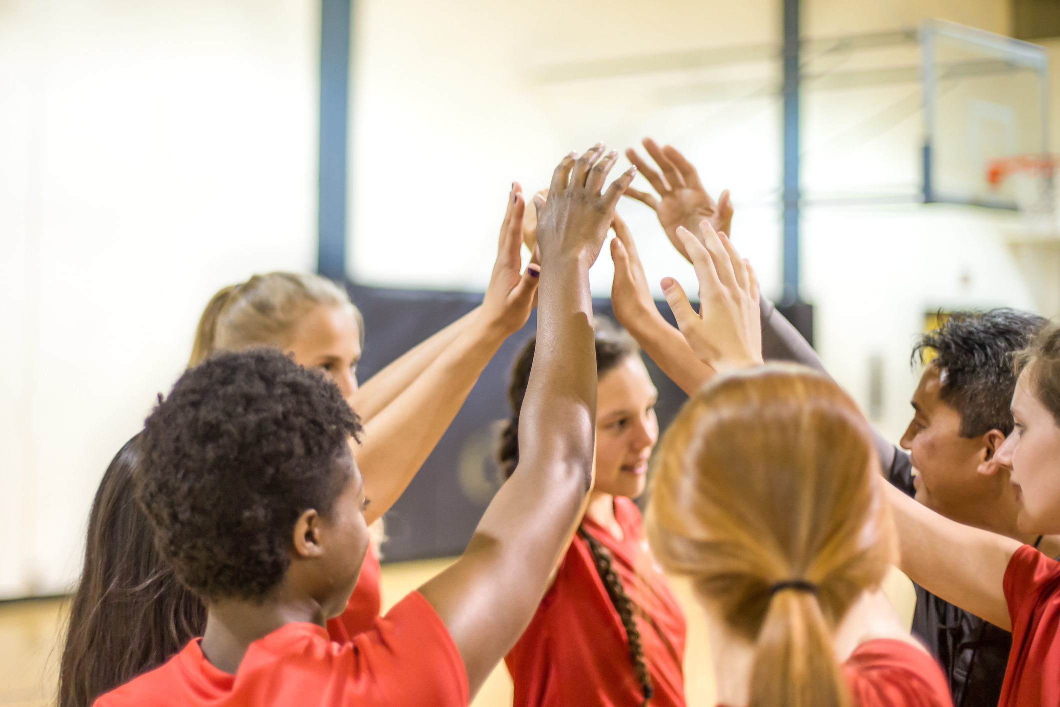 High school volleyball players in team huddle