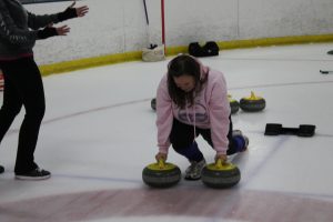 Getting the hang of curling in Oakland. 