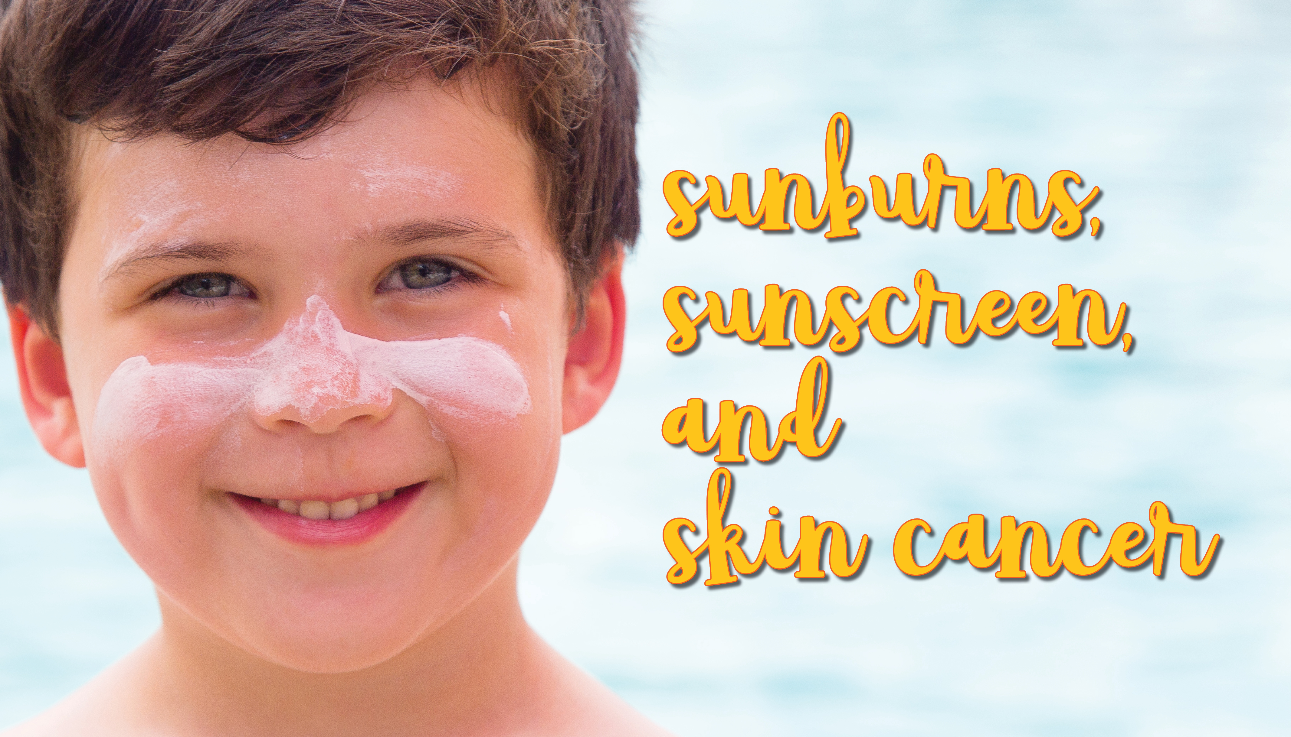 Smiling boy with sunscreen on his face