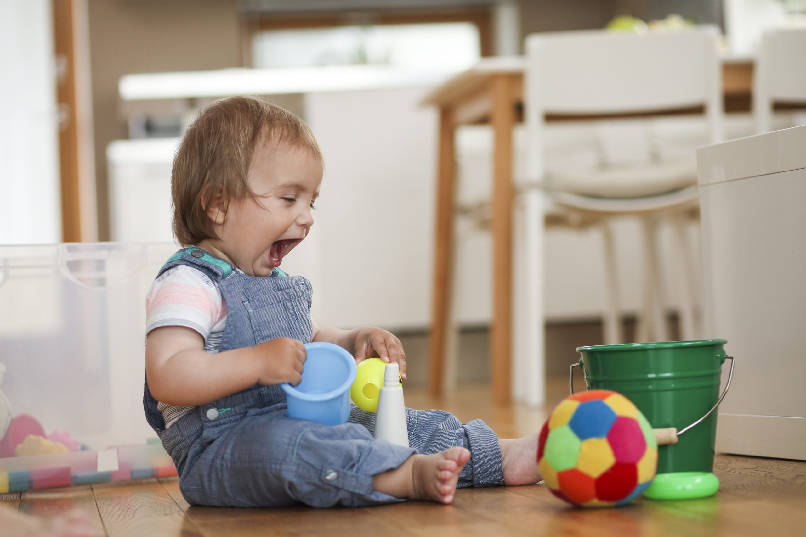 Baby laughing while playing with toys